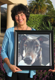 Dr. Kislak holding photo of her Greyhound